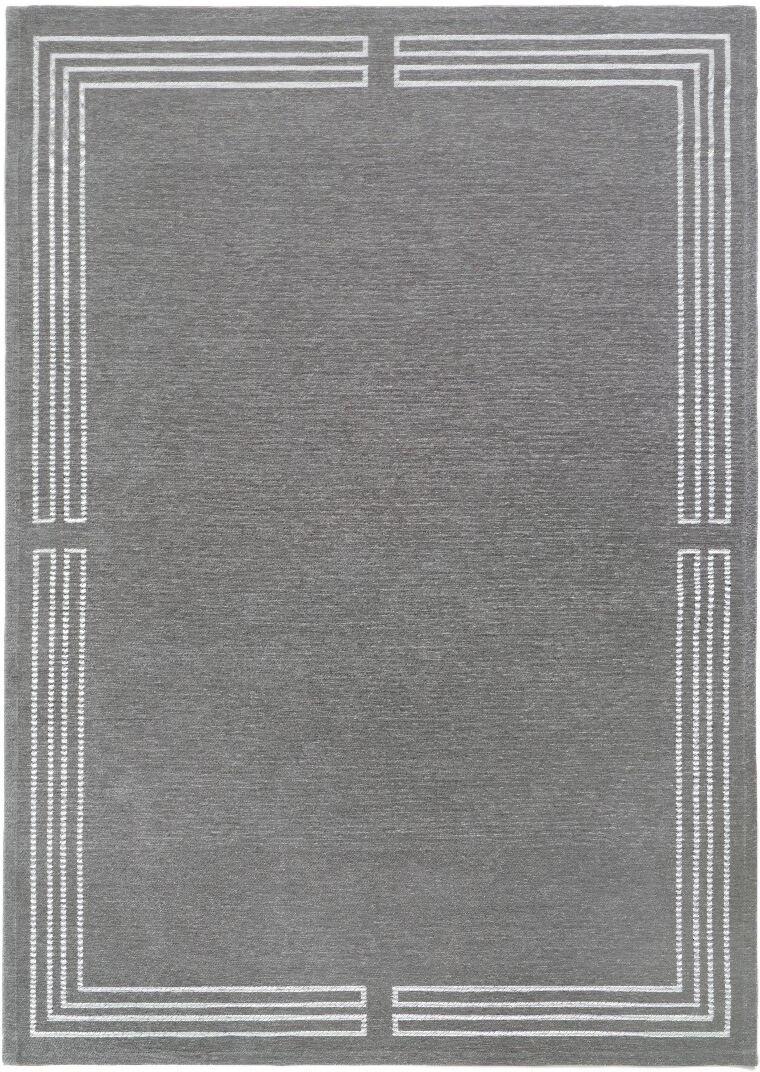 Szary dywan Royal Gray w stylu Art Deco z geometrycznym białym obramowaniem i łatwoczyszczącą powłoką Magic Home.