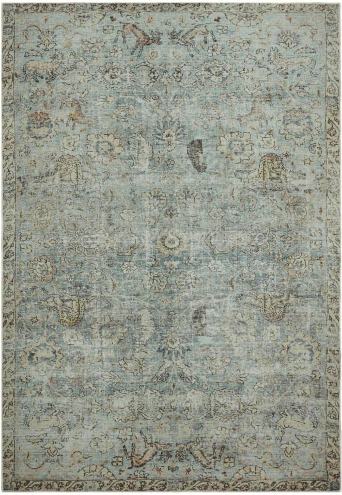 Miętowy dywan w stylu boho z orientalnym wzorem vintage, efektem przetarcia i ozdobnymi motywami zwierzęcymi.